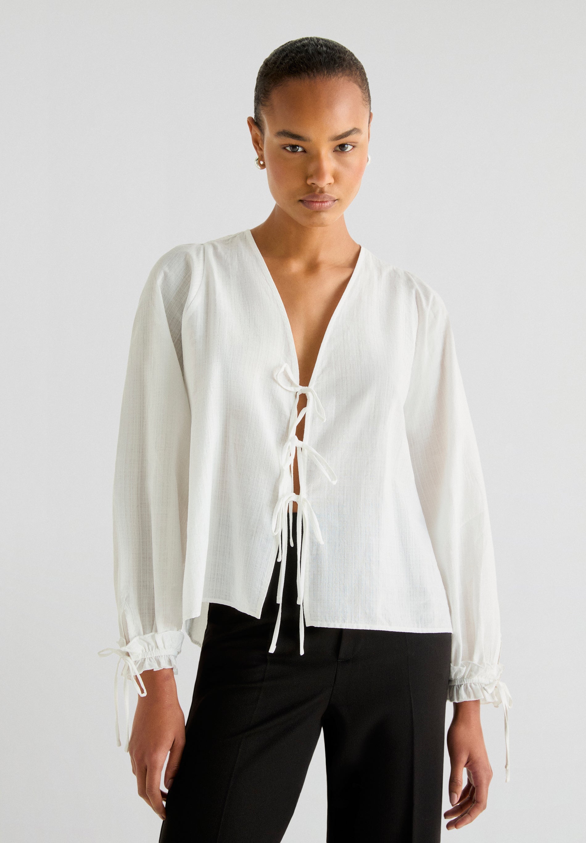 BLOUSE WITH TIE FASTENINGS